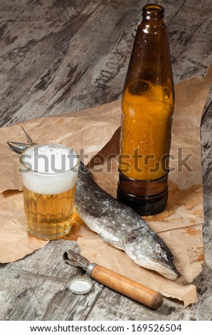 Dry fish with beer on wrapping paper From series Fun food