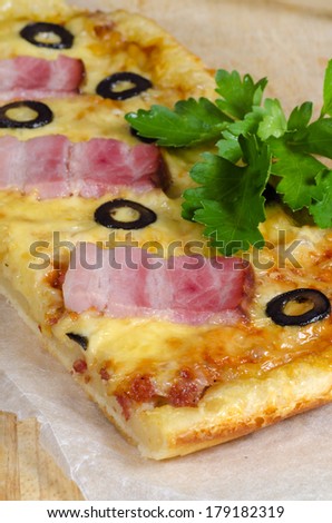 Homemade pizza with ham, cheese and olives. Selective focus. From the series Making homemade pizza