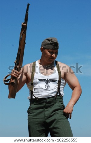 KIEV, UKRAINE -MAY 11: Member of Red Star history club wears historical German uniform during historical reenactment of WWII, may 11, 2012 in Kiev, Ukraine