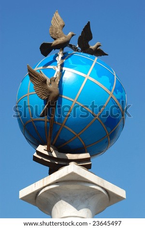 A statue of a blue terrestrial globe with doves of peace around it in Kiev, Independence square, Ukraine