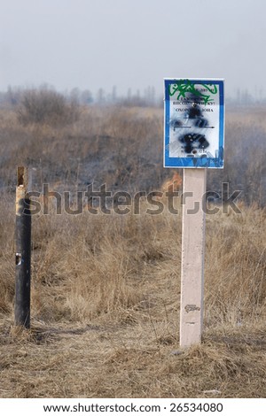 Burning Earth.Fire near natural gas pipeline sign. Near Kiev,Ukraine