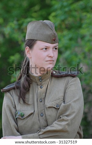 KIEV, UKRAINE - MAY 9: A member of history club called Red Star wears historical Soviet uniform as she participates in a WWII reenactment May 9, 2009 in Kiev, Ukraine
