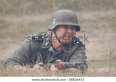 KIEV, UKRAINE - SEPT 6, : Member of a history club wears a historical German uniforms as he participates in a WWII reenactment.Defense Kiev from German troops in 1941. September 6 , 2009 in Kiev, Ukraine
