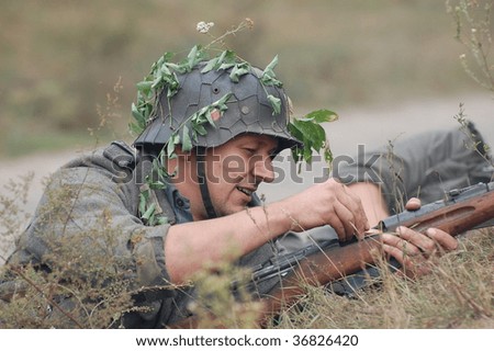 KIEV, UKRAINE - SEPT 6, : Member of a history club wears a historical German uniforms as he participates in a WWII reenactment.Defense Kiev from German troops in 1941. September 6 , 2009 in Kiev, Ukraine