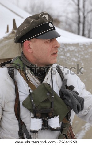 KIEV, UKRAINE - FEB 20: Member of Red Star military history club wears historical German uniform during historical reenactment of WWII,February 20, 2011 in Kiev, Ukraine