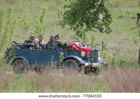 KIEV, UKRAINE - MAY 8 : Members of Red Star history club & German military jeep during historical reenactment of WWII on May 8, 2011 in Kiev, Ukraine