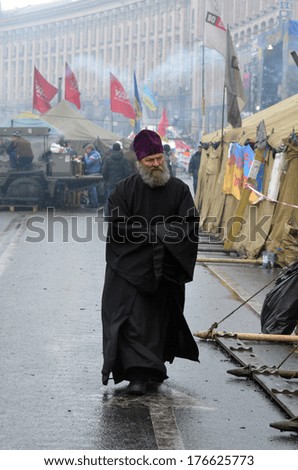 KIEV, UKRAINE - FEB 10, 2014: Downtown of Kiev. Riot in Kiev and Western Ukraine.Priest in the rioters camp.February 10, 2014 Kiev, Ukraine