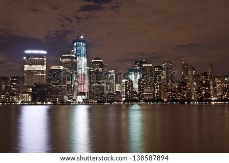 Night view of New York\'s Lower Manhattan Skyline (World Trade Center) featuring Freedom Tower from across the Hudson River.