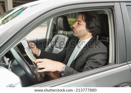 Businessman reviewing documents in the car