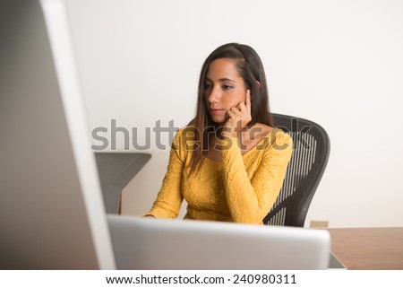 Businesswoman thinking working on her computer at the office