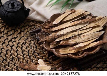 Close up of Chinese traditional herbal medicine Astragalus root on wooden table background. Foto d'archivio © 