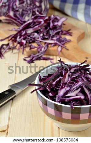 Red Cabbage in the bowl and on wooden cutting board