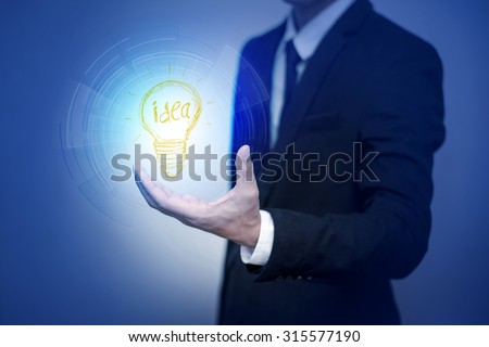business man with idea lamp on his hand,Idea concept