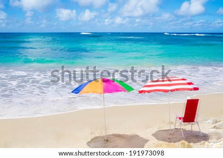 Color Beach umbrellas and chair by the ocean in sunny day