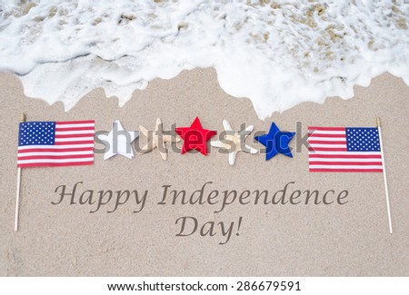 Happy Independence Day USA background with flag on the sandy beach (4th of july holiday concept)