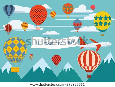 Advertising banners pulled by a plane with hot air balloons flying around.