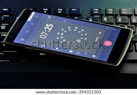 Smart Phone With Alarm Clock Screen  On Computer Keyboard