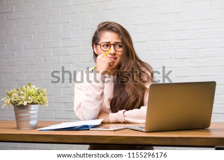 Portrait of young student latin woman sitting on her desk biting nails, nervous and very anxious and scared for the future, feels panic and stress Stock foto © 