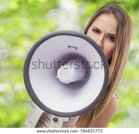 beautiful young woman shouting with a megaphone