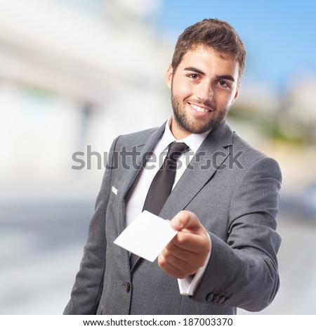 portrait of handsome business man offering his visit card