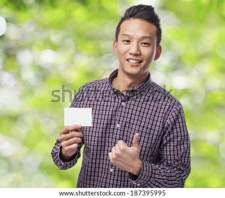 Handsome young man holding an empty visit card