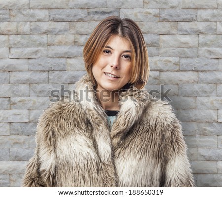 beautiful young woman wearing a fur coat