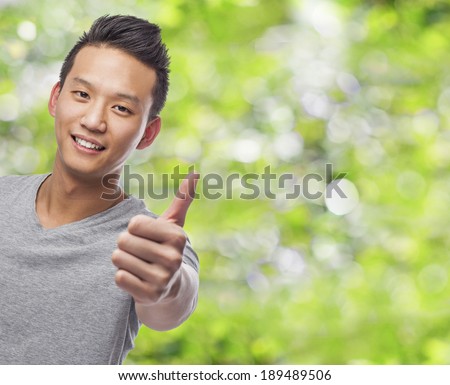 portrait of young asian man with thumb up