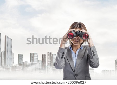 portrait of an executive young woman looking through the binoculars