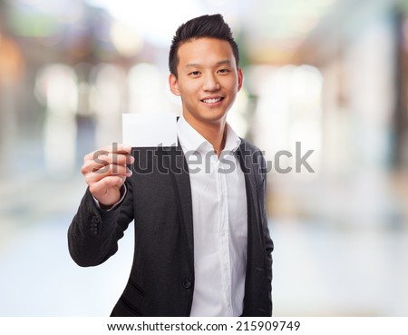 portrait of an asian man holding a white card