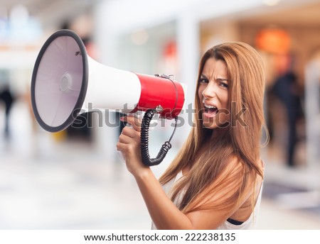 portrait of a young woman shouting with a megaphone
