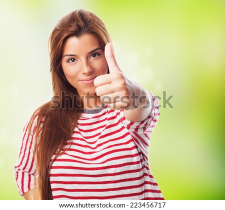 A pretty young woman with thumb up