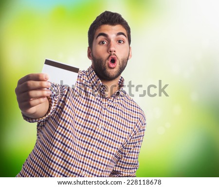 portrait of a young man holding a credit card