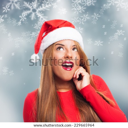 portrait of a beautiful young woman at Christmas with thinking gesture