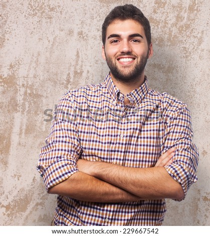 Portrait of a handsome young man with crossed arms