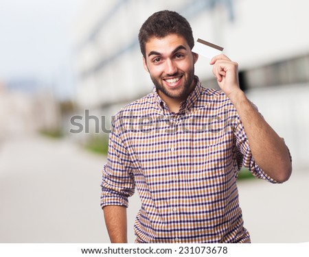 portrait of a handsome young man holding a credit card