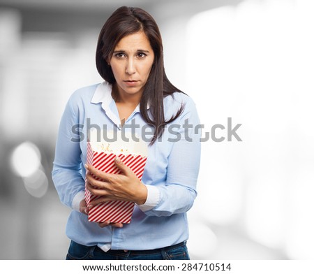 scared young woman with popcorn