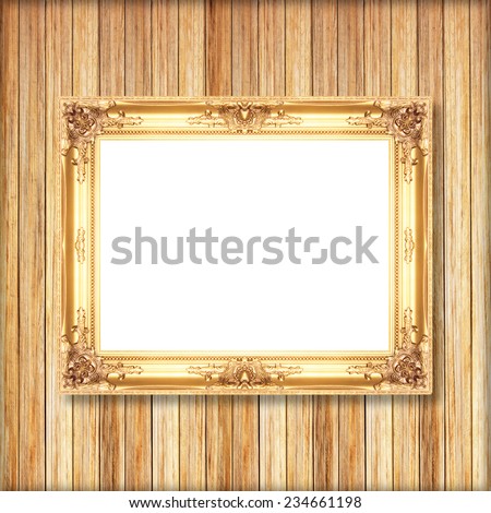 Antique gold frame on wooden wall;. Empty  picture frame on wooden wall.