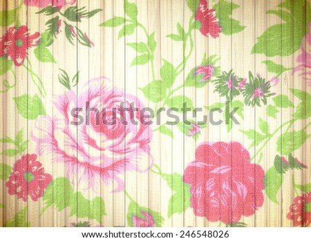 Red rose vintage from fabric on white wooden background.