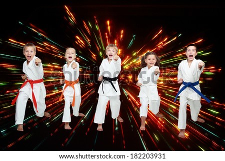 Boys and girls are beating blows arms on black background with colored flares