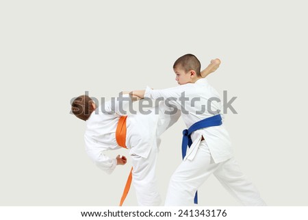 Little athletes perform paired exercises karate