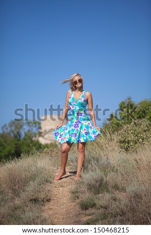 Beautiful young woman wearing bright dress