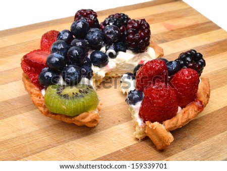 Fresh fruit tart on wooden board
