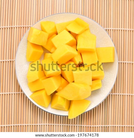 slice of mango in plate, on bamboo mat saved with clipping path