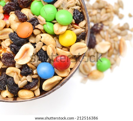 trail mix in wooden bowl on white background