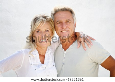 Happy mature couple smiling and embracing.