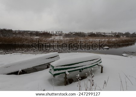 The boat in the winter at the river