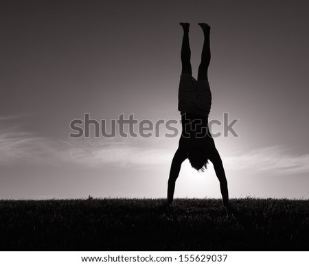 Silhouette of male doing gymnastics