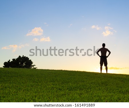 Silhouette of the person on sun glow background. Sport and active life