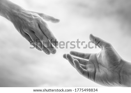 Giving a helping hand to a friend in need. Hand reaching out to another. Foto d'archivio © 
