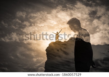 Brave man standing on a mountain overcoming his fears, self doubt, mental depression, sadness concept. double exposure